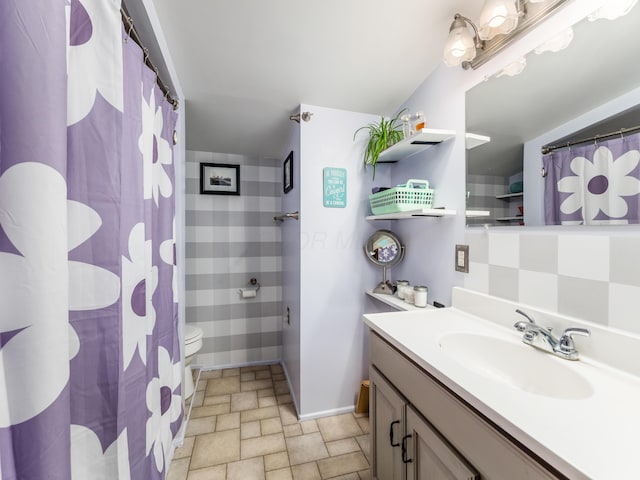 bathroom with toilet, vanity, and a shower with shower curtain