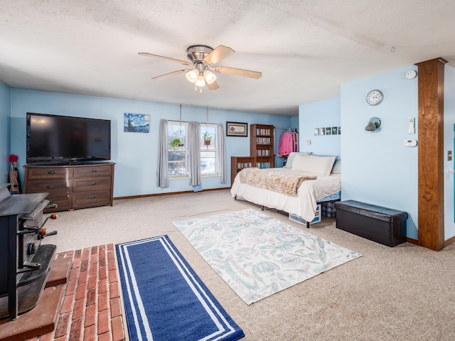 carpeted bedroom with a textured ceiling and ceiling fan