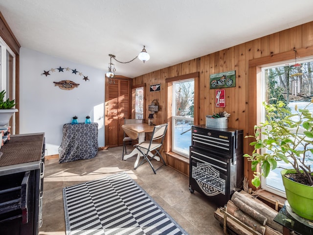 misc room with plenty of natural light and wooden walls