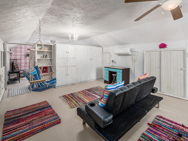 living room featuring an AC wall unit, vaulted ceiling, ceiling fan with notable chandelier, and a textured ceiling