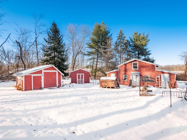 yard layered in snow with a shed