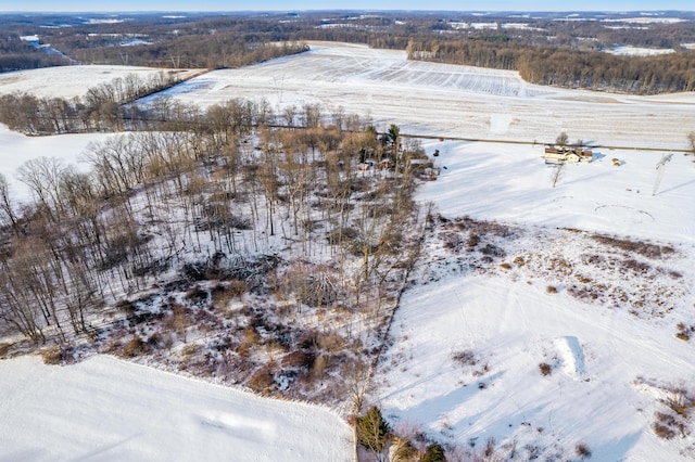 snowy aerial view featuring a rural view