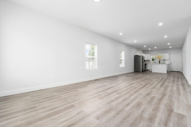 unfurnished living room featuring light hardwood / wood-style flooring