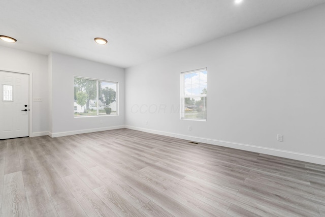 interior space with light hardwood / wood-style floors and a wealth of natural light