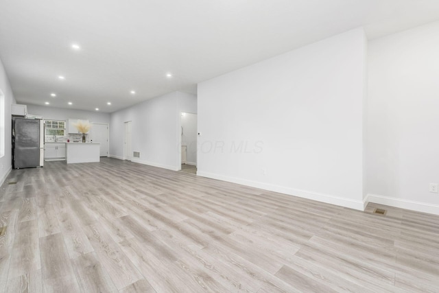 unfurnished living room featuring light hardwood / wood-style flooring