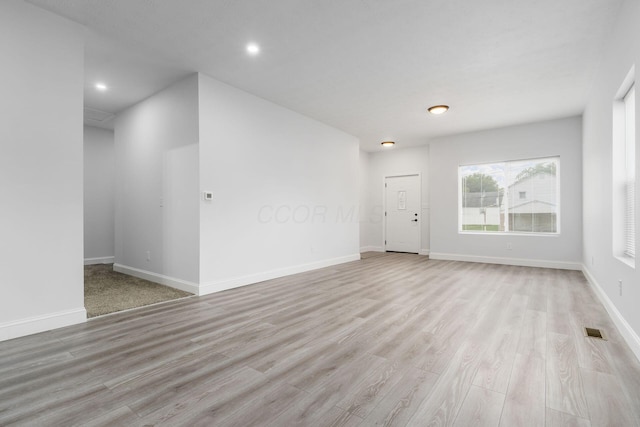 spare room featuring light wood-type flooring