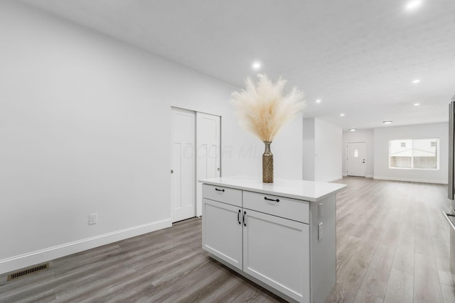 kitchen with a center island and light hardwood / wood-style flooring