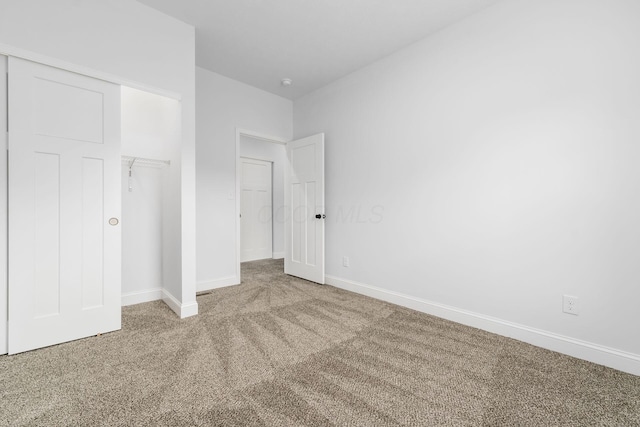 unfurnished bedroom with a closet and carpet floors