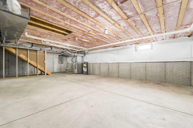 basement with electric water heater and heating unit