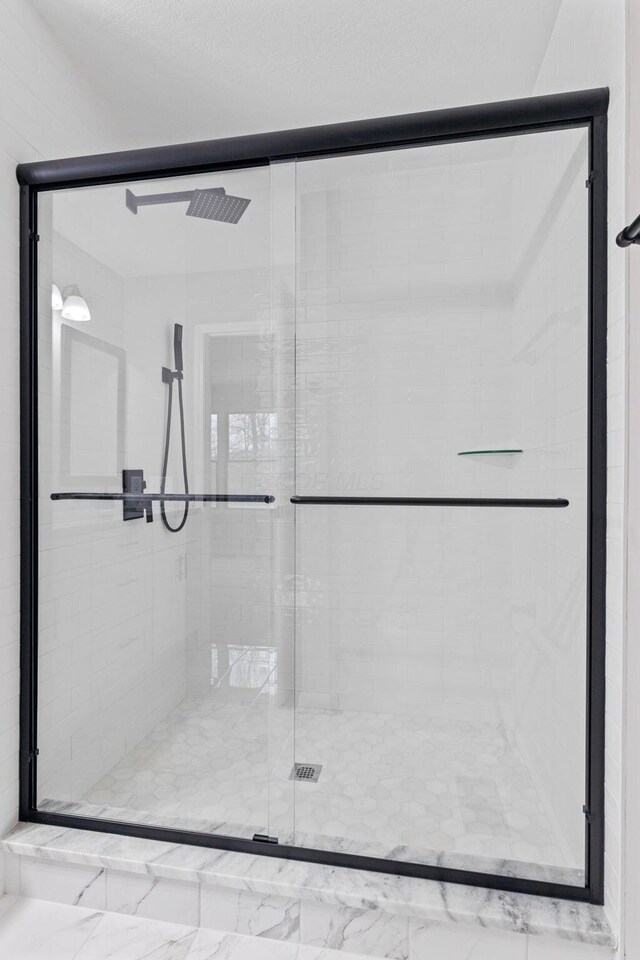 bathroom featuring an enclosed shower