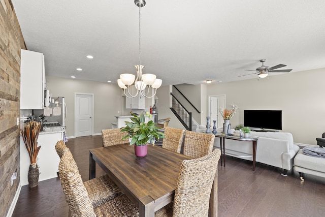 dining space featuring a textured ceiling, dark hardwood / wood-style floors, and ceiling fan with notable chandelier