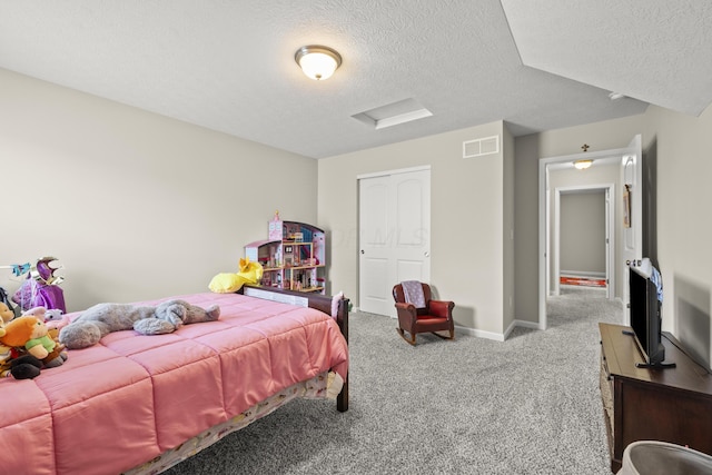 carpeted bedroom featuring a textured ceiling