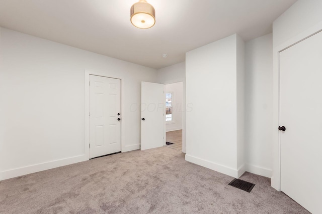 unfurnished bedroom featuring light colored carpet