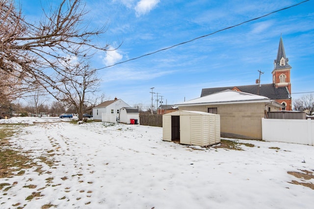 snowy yard with a storage unit