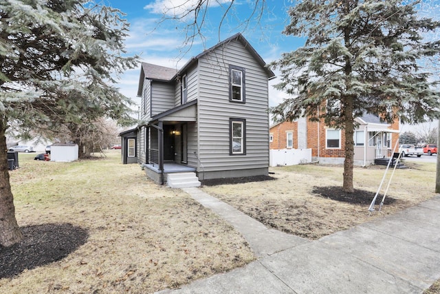 front facade with a front lawn and a storage unit