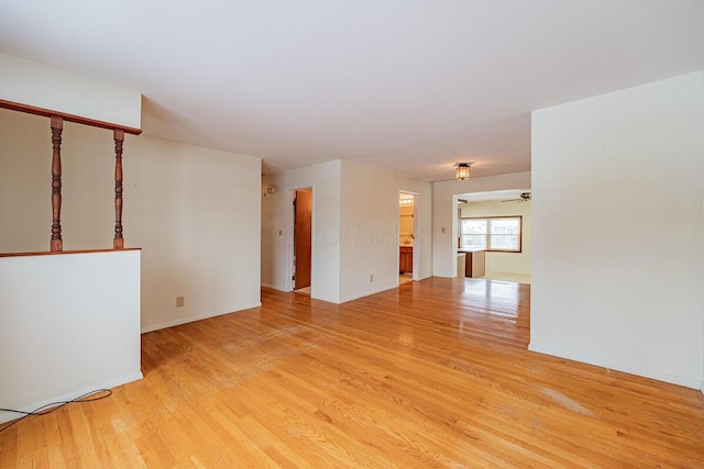 unfurnished living room with ceiling fan and light hardwood / wood-style floors