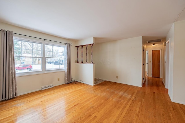 spare room featuring light hardwood / wood-style flooring