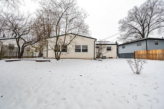 view of snow covered rear of property