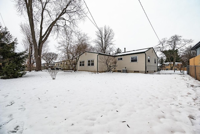 snow covered house with cooling unit