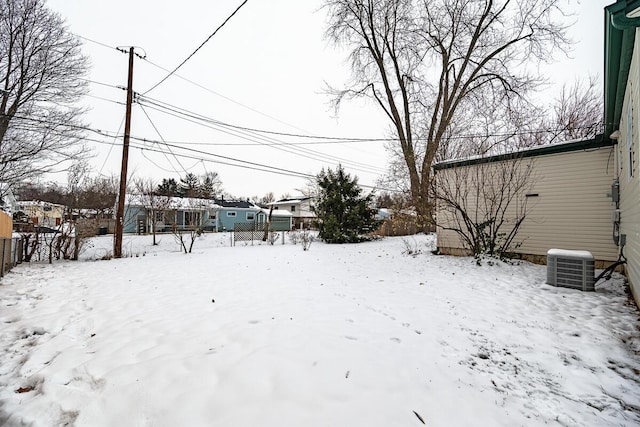 yard covered in snow with central AC unit