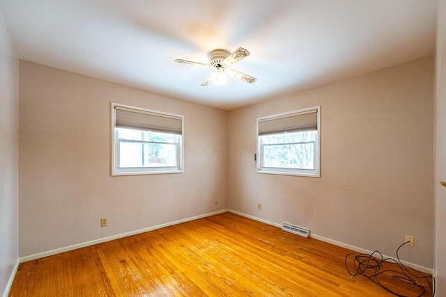 empty room featuring light wood-type flooring and ceiling fan