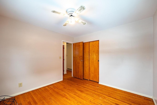 spare room with light wood-type flooring and ceiling fan