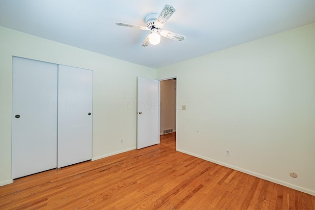 unfurnished bedroom with ceiling fan, a closet, and light wood-type flooring