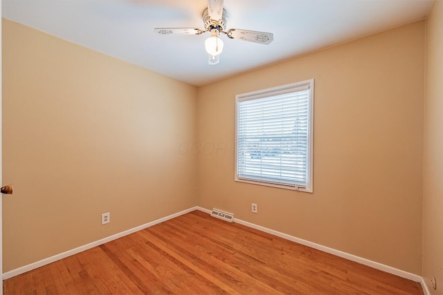 unfurnished room with ceiling fan and hardwood / wood-style floors