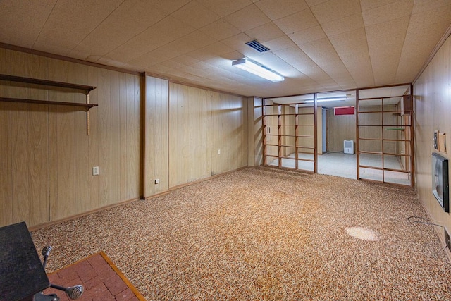 basement with carpet floors and wood walls