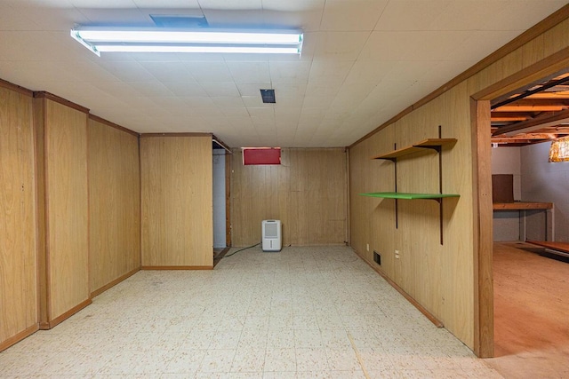 basement featuring wood walls