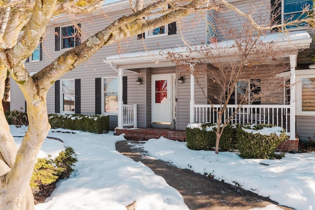 view of snow covered property entrance