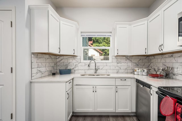 kitchen featuring sink, appliances with stainless steel finishes, dark hardwood / wood-style floors, decorative backsplash, and white cabinets