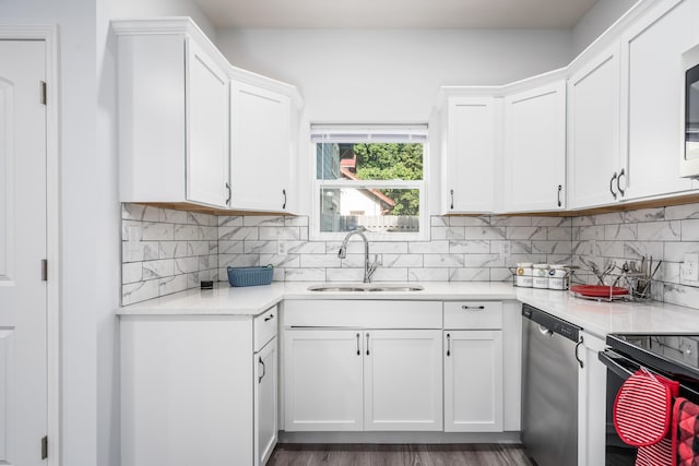 kitchen with appliances with stainless steel finishes, sink, decorative backsplash, and white cabinets