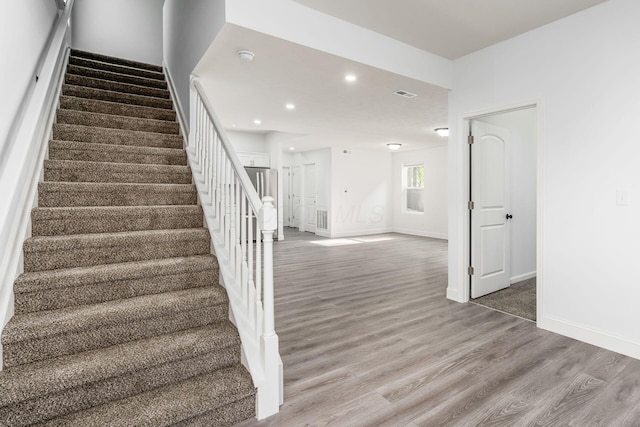 stairway featuring hardwood / wood-style floors