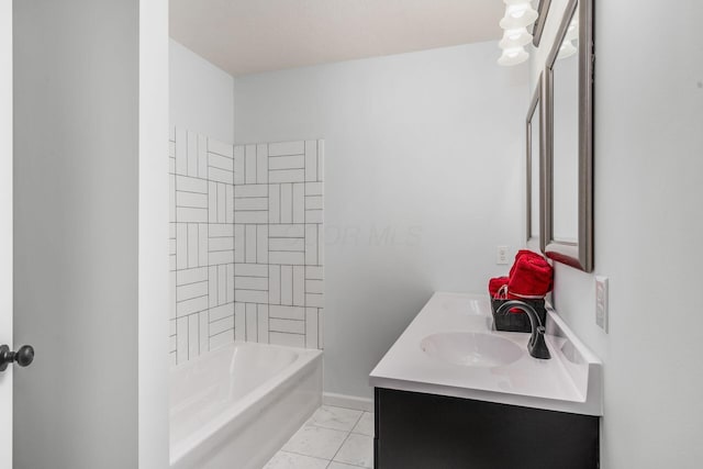 bathroom featuring tiled shower / bath and vanity