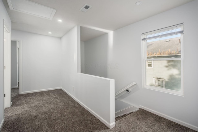 hall featuring dark colored carpet