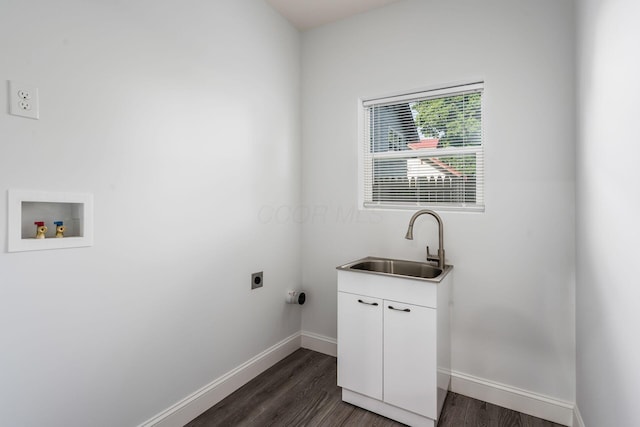 washroom with dark wood-type flooring, sink, cabinets, hookup for a washing machine, and hookup for an electric dryer