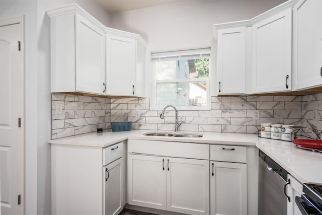 kitchen with white cabinetry, dishwasher, and sink