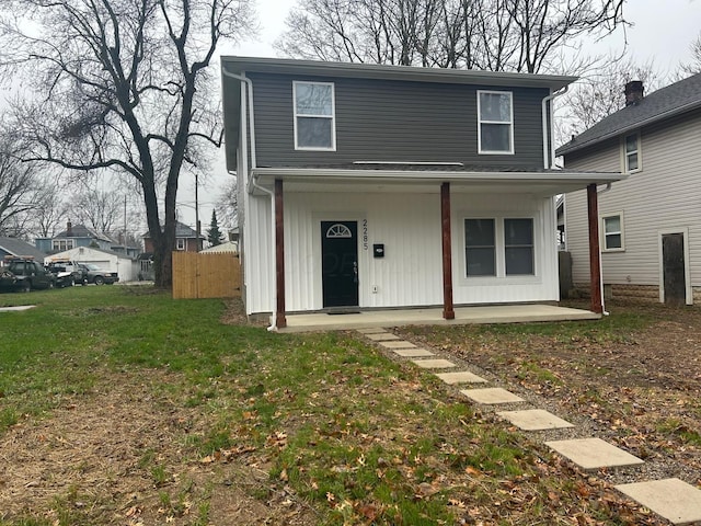 front facade with covered porch and a front lawn