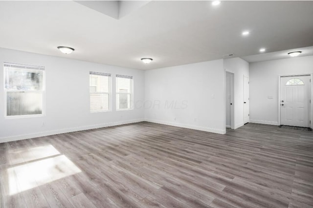 spare room with wood-type flooring