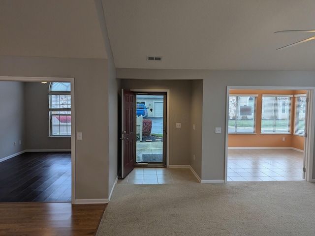 entrance foyer featuring light colored carpet and ceiling fan