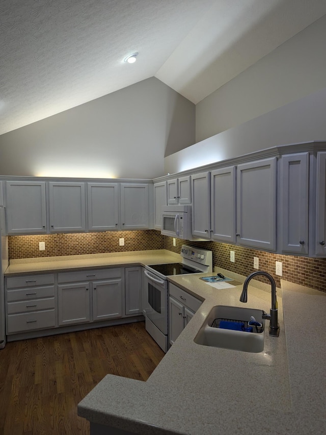 kitchen featuring sink, tasteful backsplash, high vaulted ceiling, white appliances, and gray cabinets