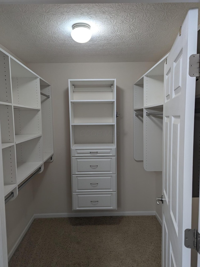 spacious closet featuring dark carpet