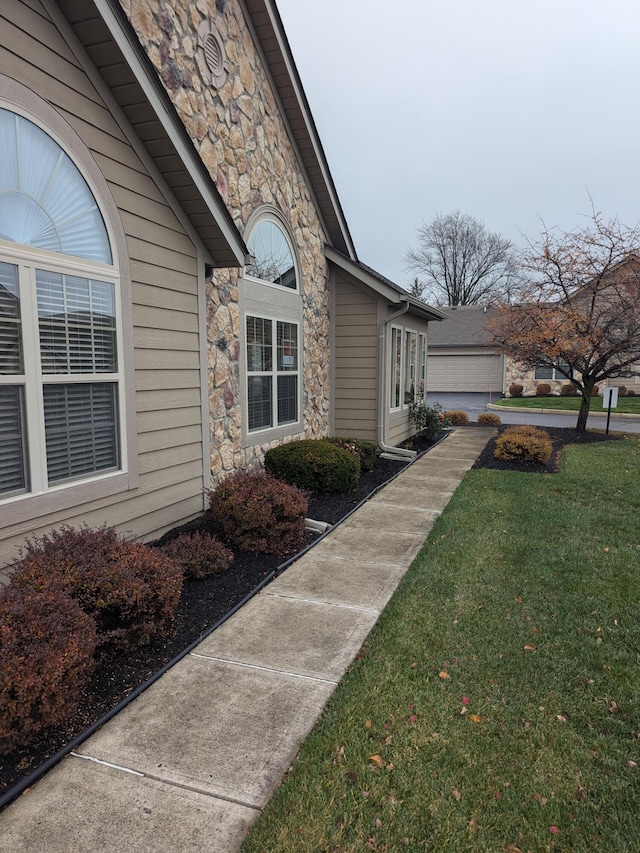 view of property exterior with a yard