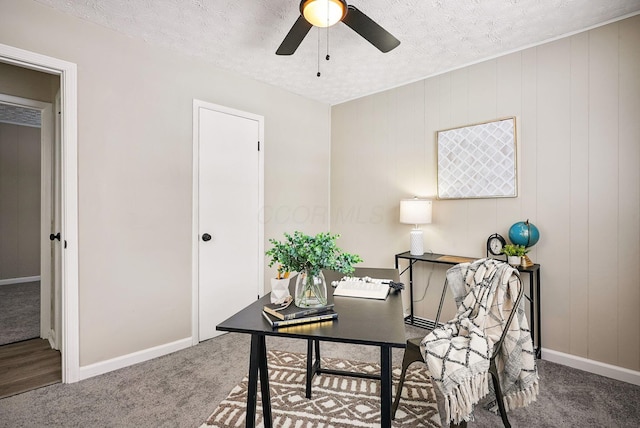 office area featuring a textured ceiling, ceiling fan, and carpet