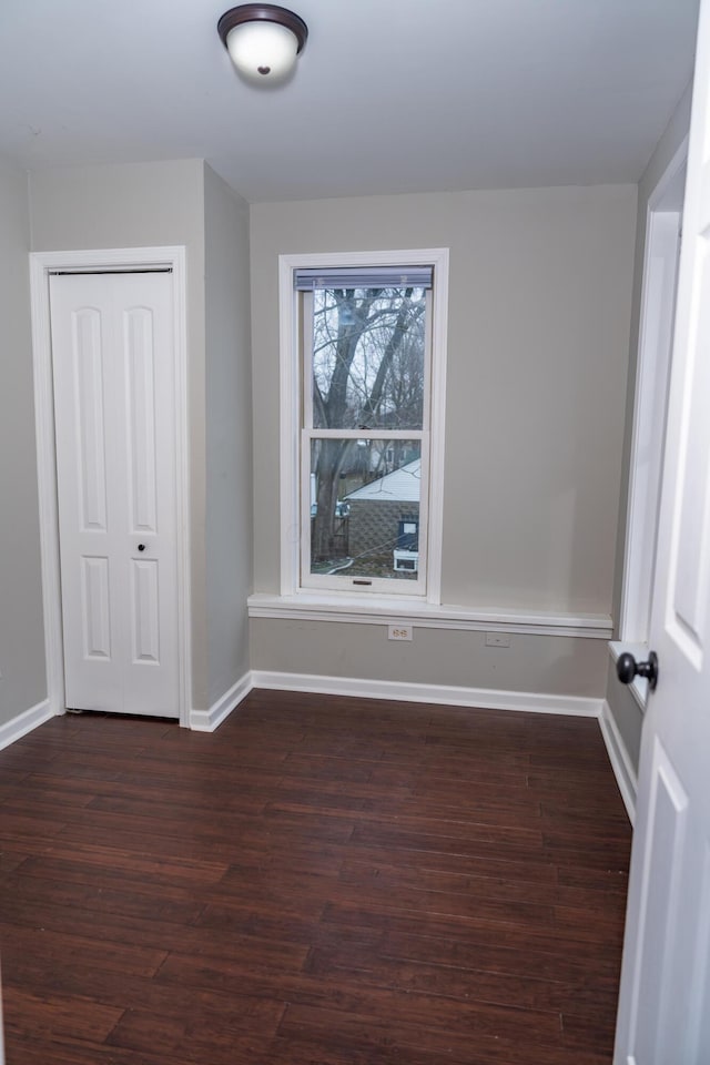 empty room featuring dark wood-type flooring