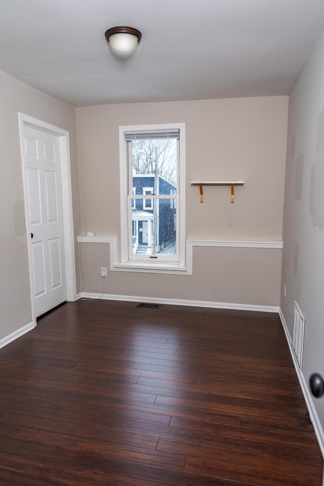 unfurnished room with dark hardwood / wood-style floors