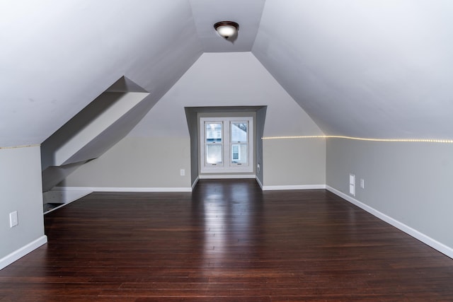 additional living space with lofted ceiling and dark hardwood / wood-style flooring