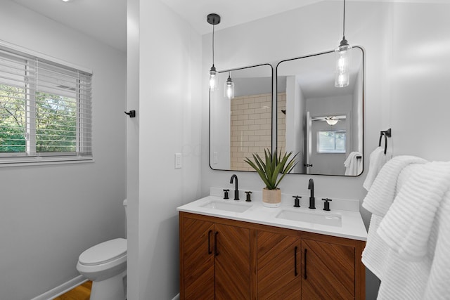 bathroom with vanity, a healthy amount of sunlight, and toilet