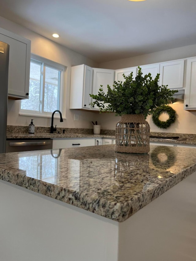 kitchen featuring white cabinetry, sink, dishwasher, and stone counters